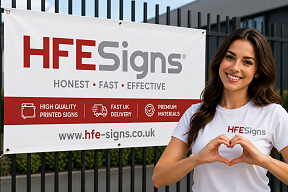 Woman making heart shape with hands beside HFE Signs printed advertising banner with fast UK delivery branding Woman making heart shape with hands beside HFE Signs printed advertising banner with fast UK delivery branding