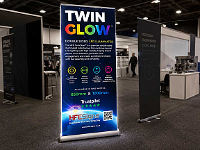 TwinGlow illuminated double-sided roller banner display at exhibition stand, brighter than standard pull-up banners TwinGlow illuminated double-sided roller banner display at exhibition stand, brighter than standard pull-up banners